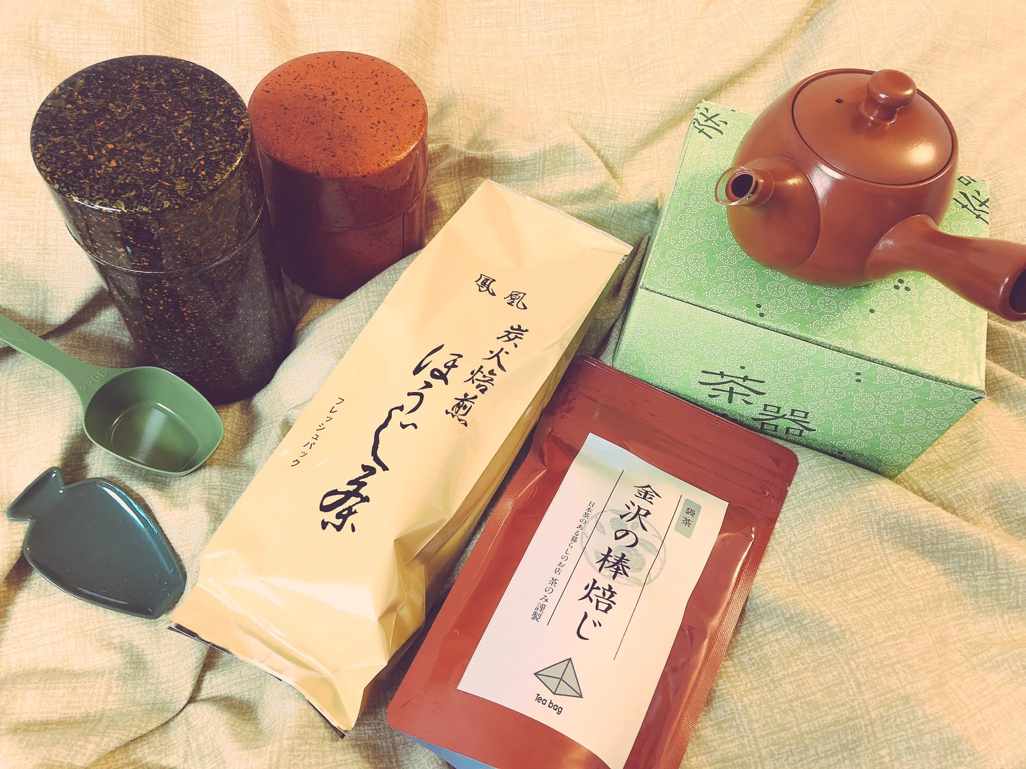 Japanese tea leaves and a red side-handled kyusu teapot
