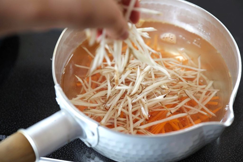 Julienned Gobo Soaking Before Cooking Julienned gobo and carrot soaking in water before cooking