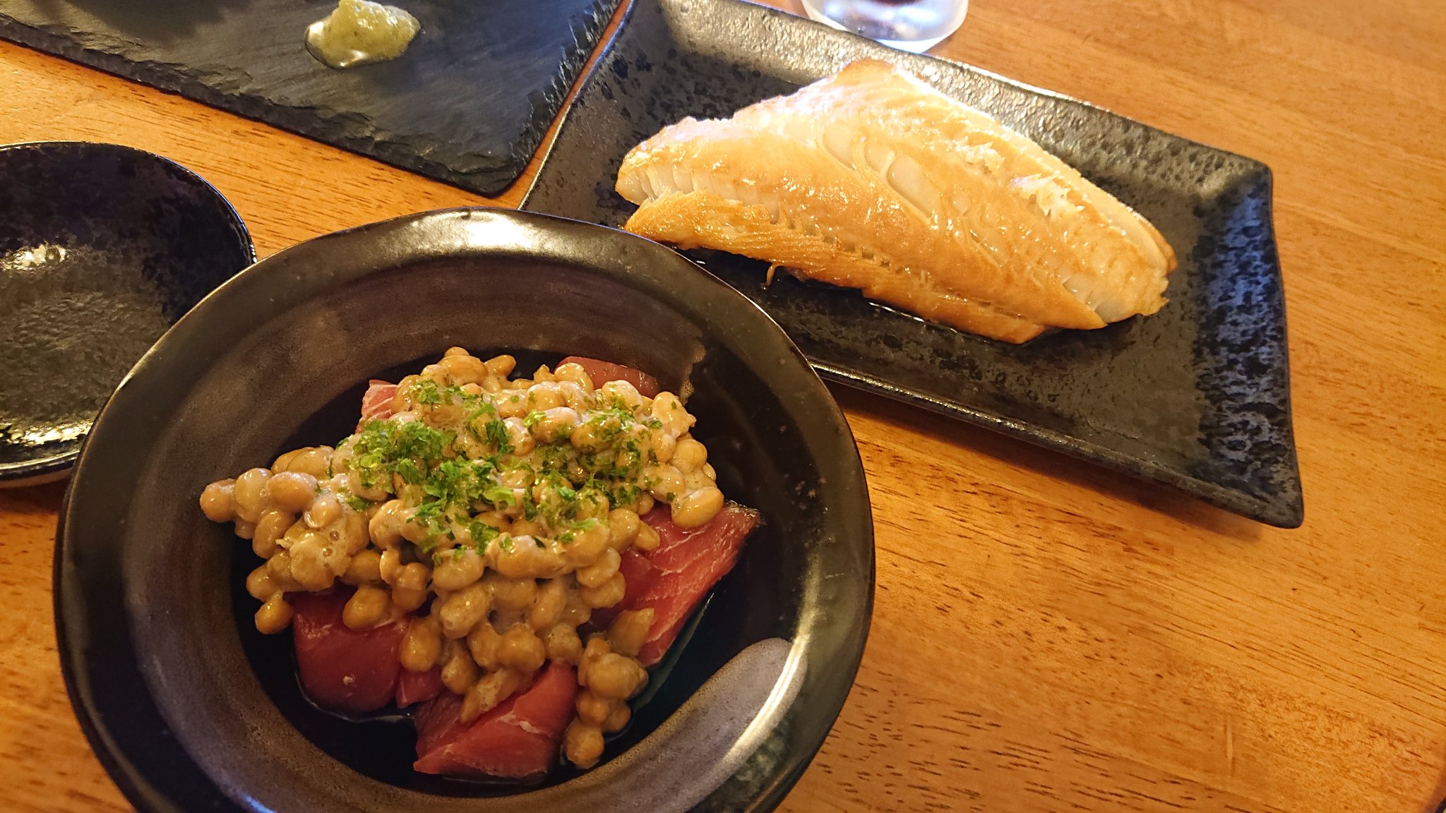 Maguro Natto with Tuna Sashimi Maguro natto served with sliced tuna sashimi at a Japanese restaurant