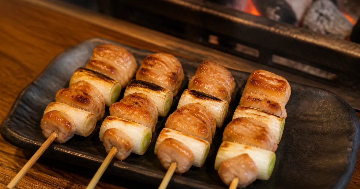 Four negima yakitori skewers with grilled chicken and Japanese long onion