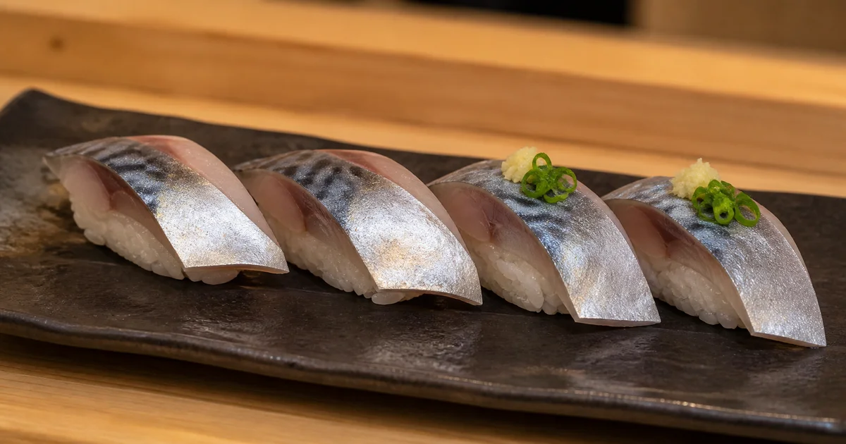 Four pieces of saba mackerel nigiri with ginger and green onion