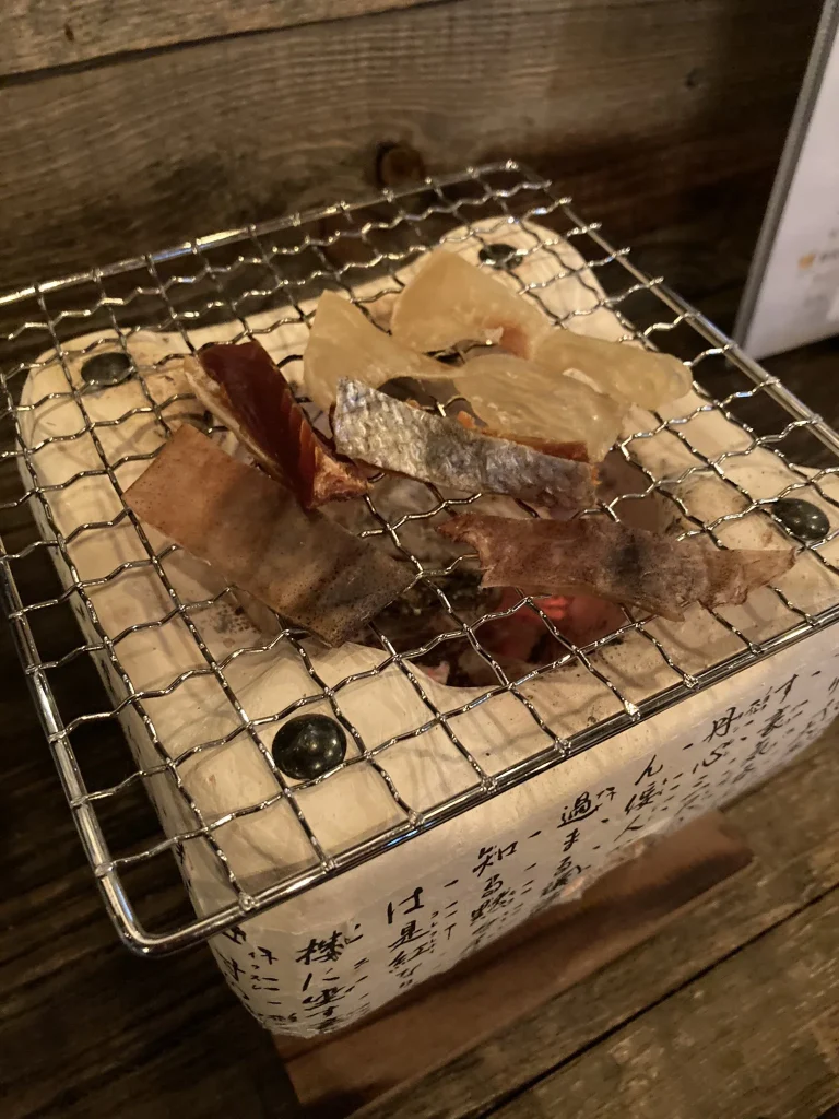 Small ceramic shichirin with a wire grate and glowing charcoal