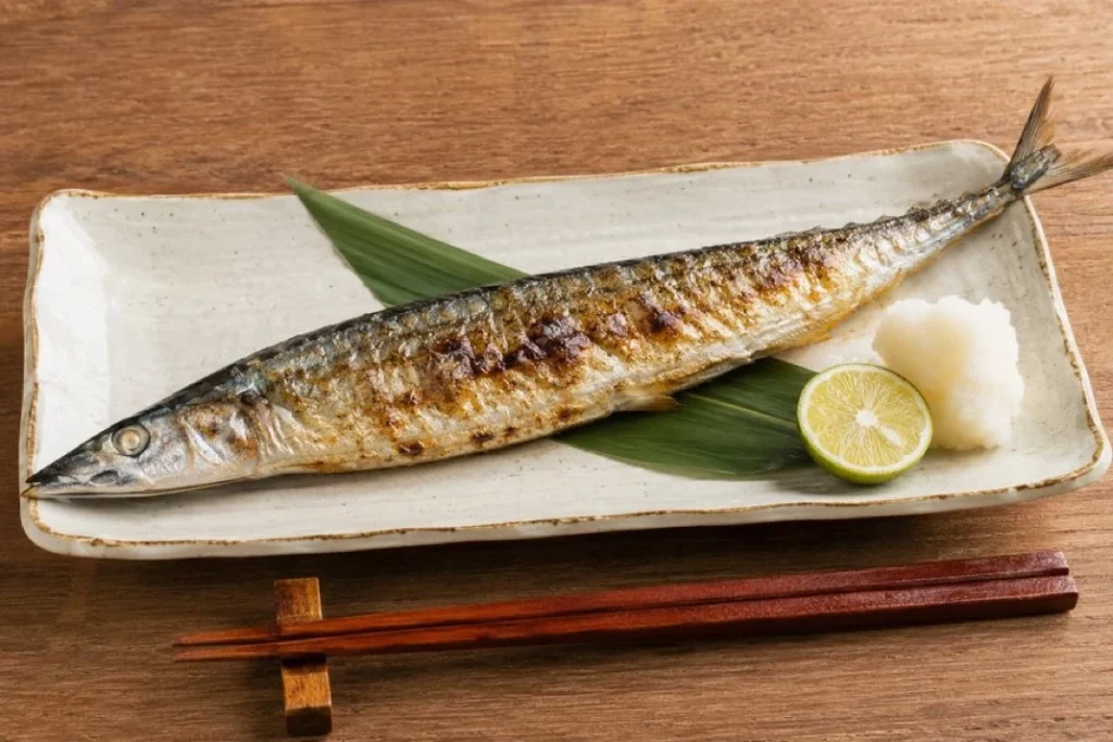 Salt-Grilled Sanma With Daikon and Sudachi Whole salt-grilled sanma served with grated daikon and a halved green sudachi citrus