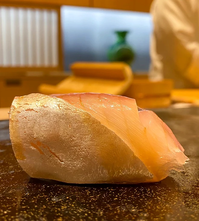 Nigiri made with a silver-skinned fish at a Japanese sushi counter