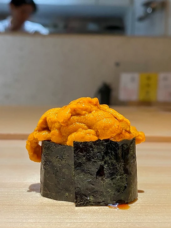 Sea urchin uni gunkan sushi served at a Japanese sushi counter